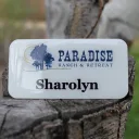 A white metal nametag with the clear domed Tag Armor coating
