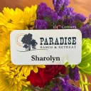A white metal nametag