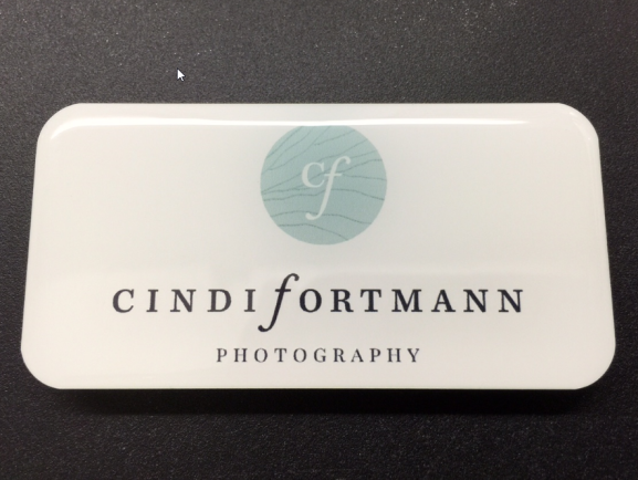 White metal nametag with epoxy coating. Design for Cindi Fortmann photography.