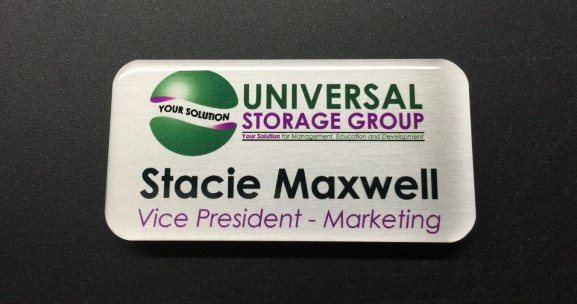 Brushed silver metal nametag with epoxy coating. Design for Universal Storage Group.