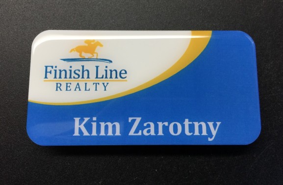 White metal nametag. Design for Finish Line Realty.