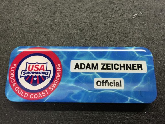 White metal nametag with epoxy coating. Design for USA Swimming - Florida Gold Coast Swimming.
