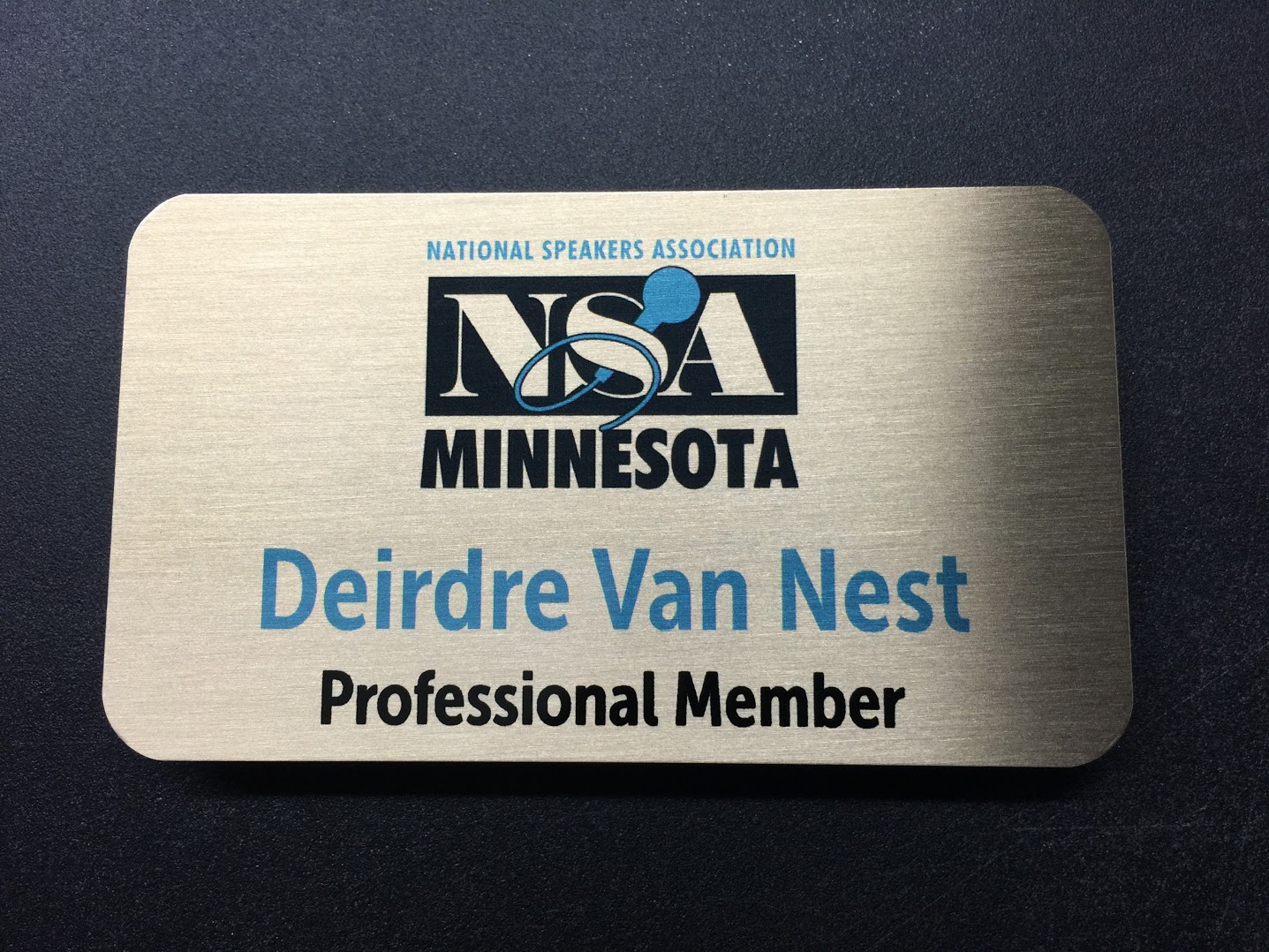A brushed silver nametag. Design for National Speakers Association Minnesota.