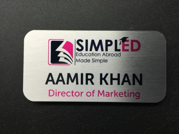 Brushed silver name badge. Logo for SimplEd, Education Abroad Made Simple.
