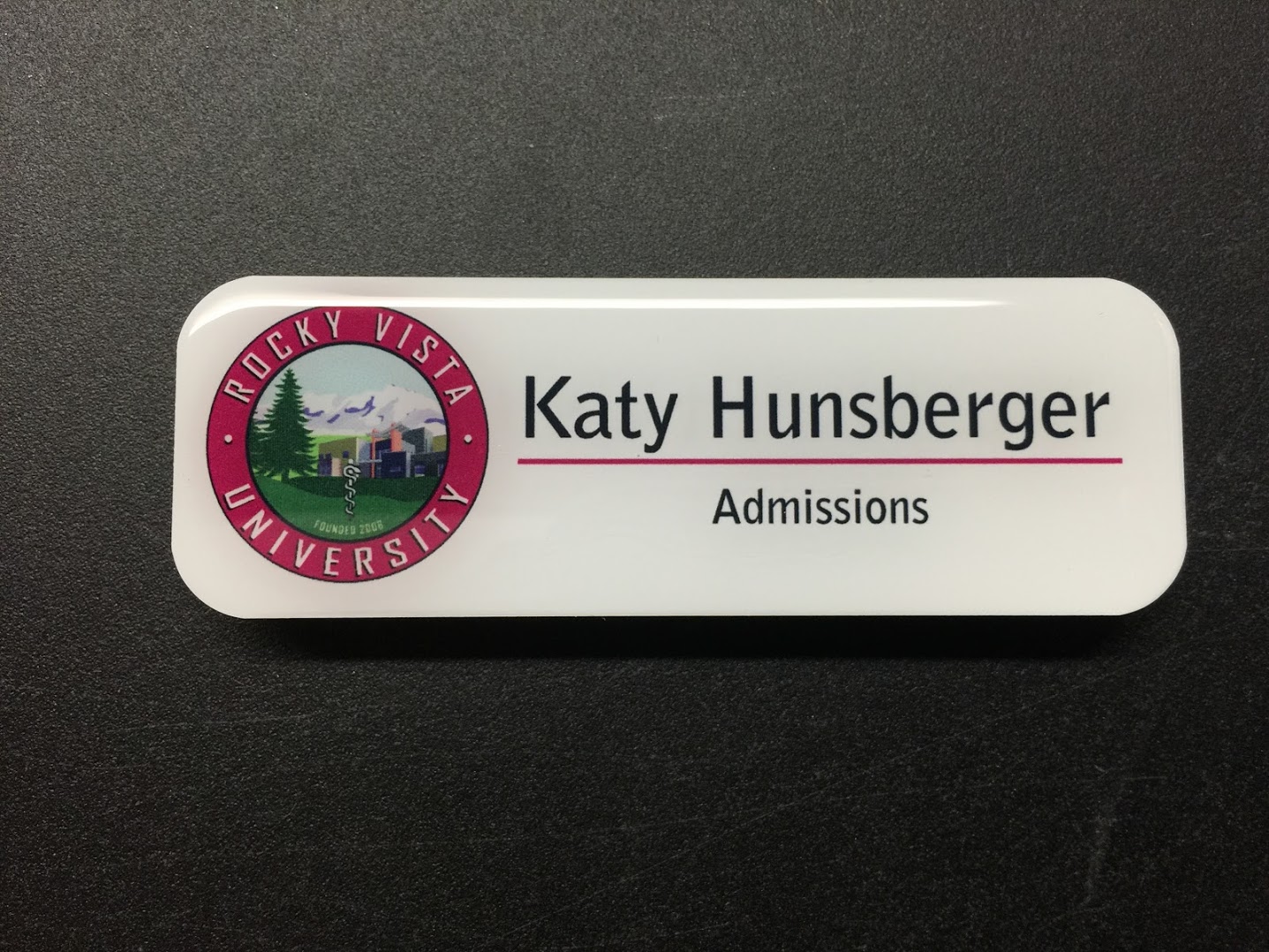 A white name badge with epoxy coating. Design for Rocky Vista University.