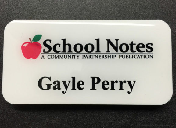 Custom white metal nametag with epoxy coating. Design for School Notes.