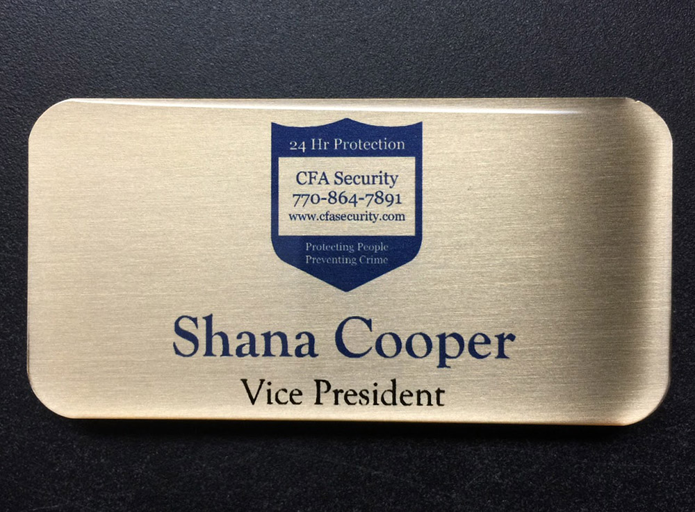 Brushed silver nametag with epoxy coating. Design for CFA Security.