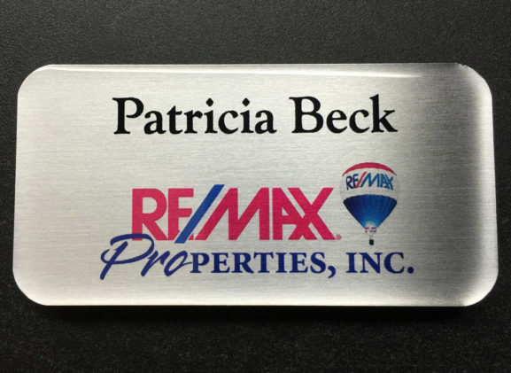 Brushed silver name badge, custom. Design for Re/Max Properties.