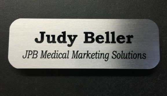 Brushed silver name badge. Design for JPB Medical Marketing Solutions.